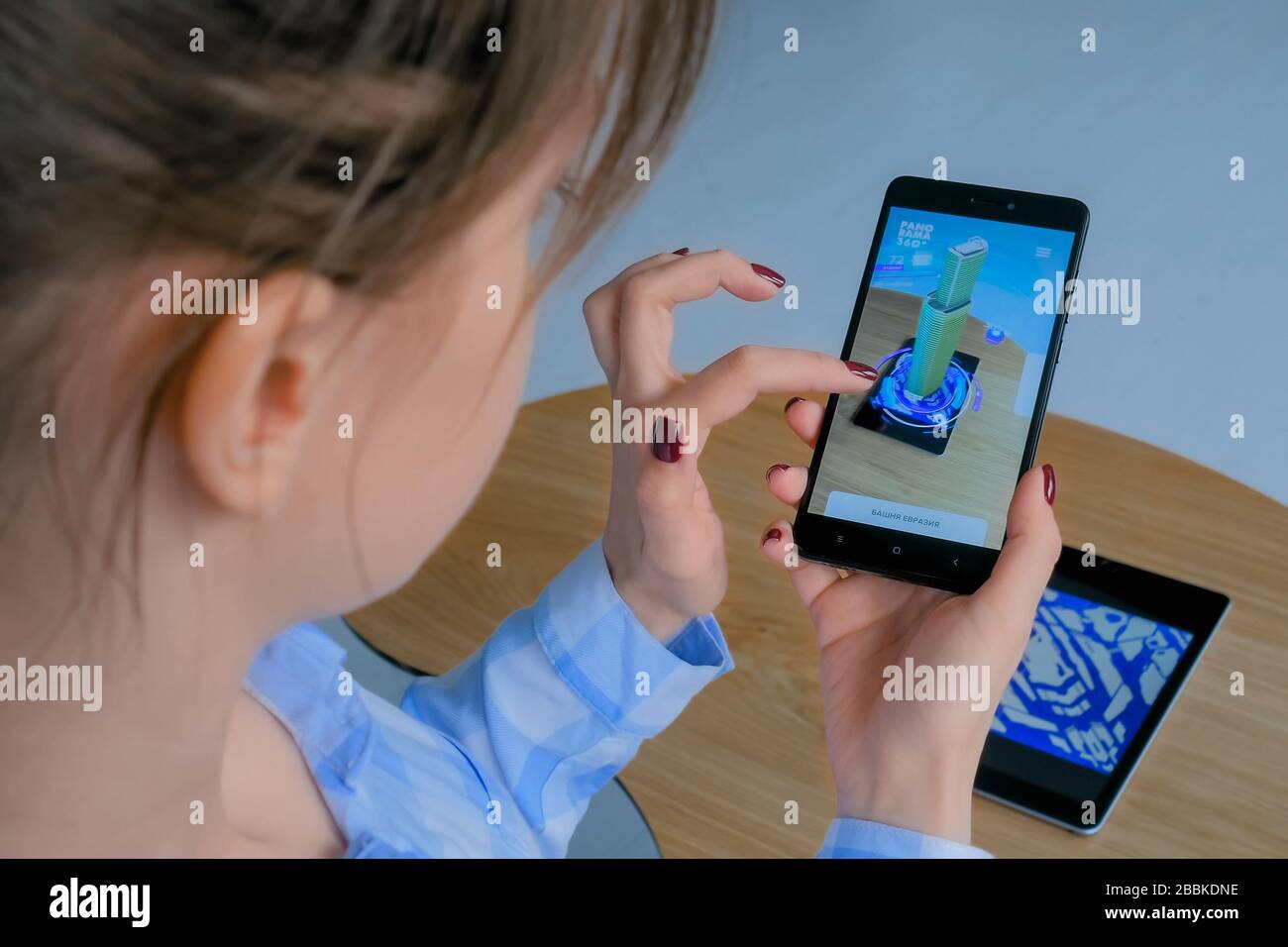 Woman using smartphone with augmented reality app Stock Photo