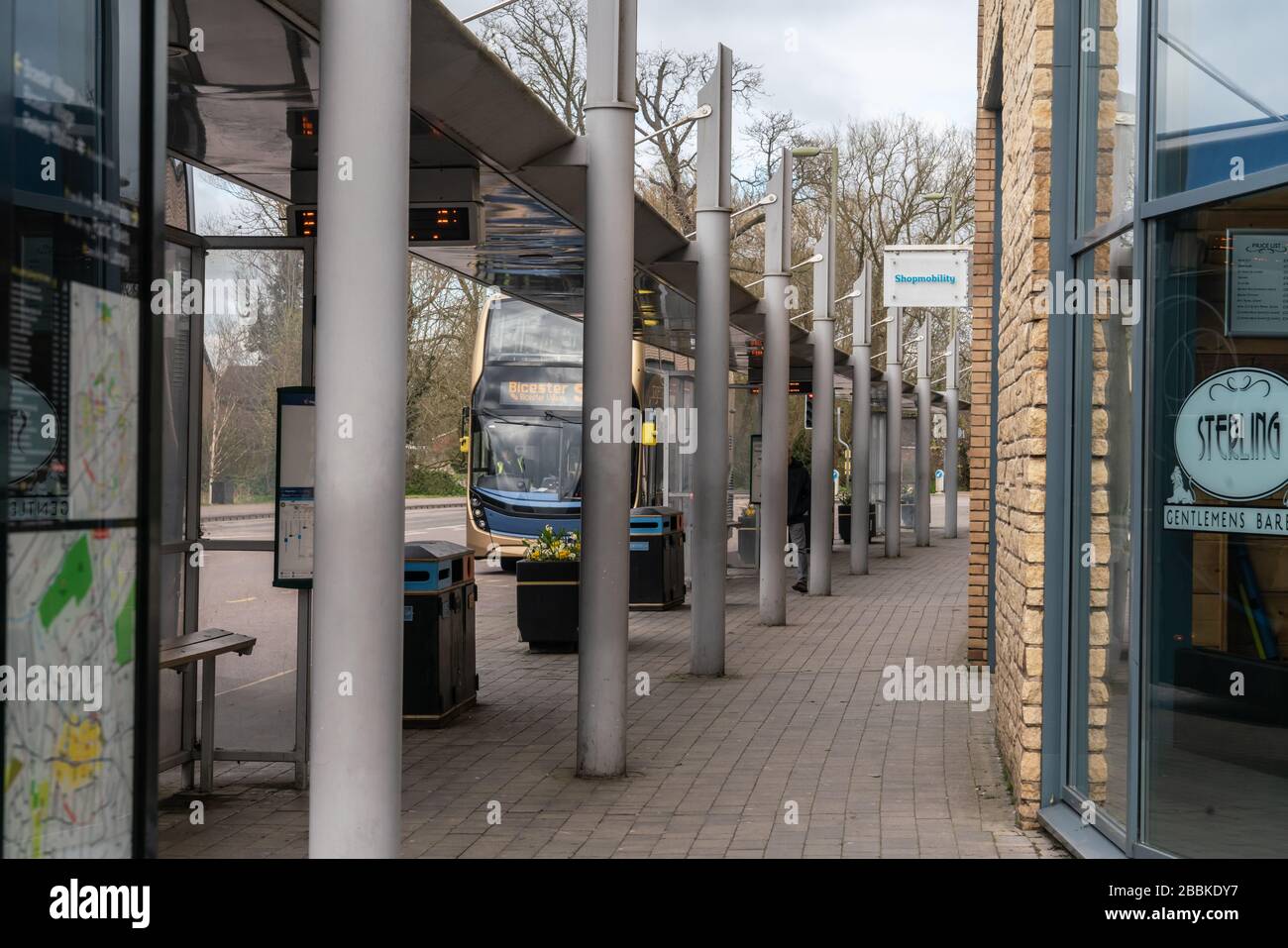 A deserted bus stop in Bicester, Oxfordshire, late morning, illustrates the impact of social distancing measures. Stay at Home directive. UK lockdown. Stock Photo
