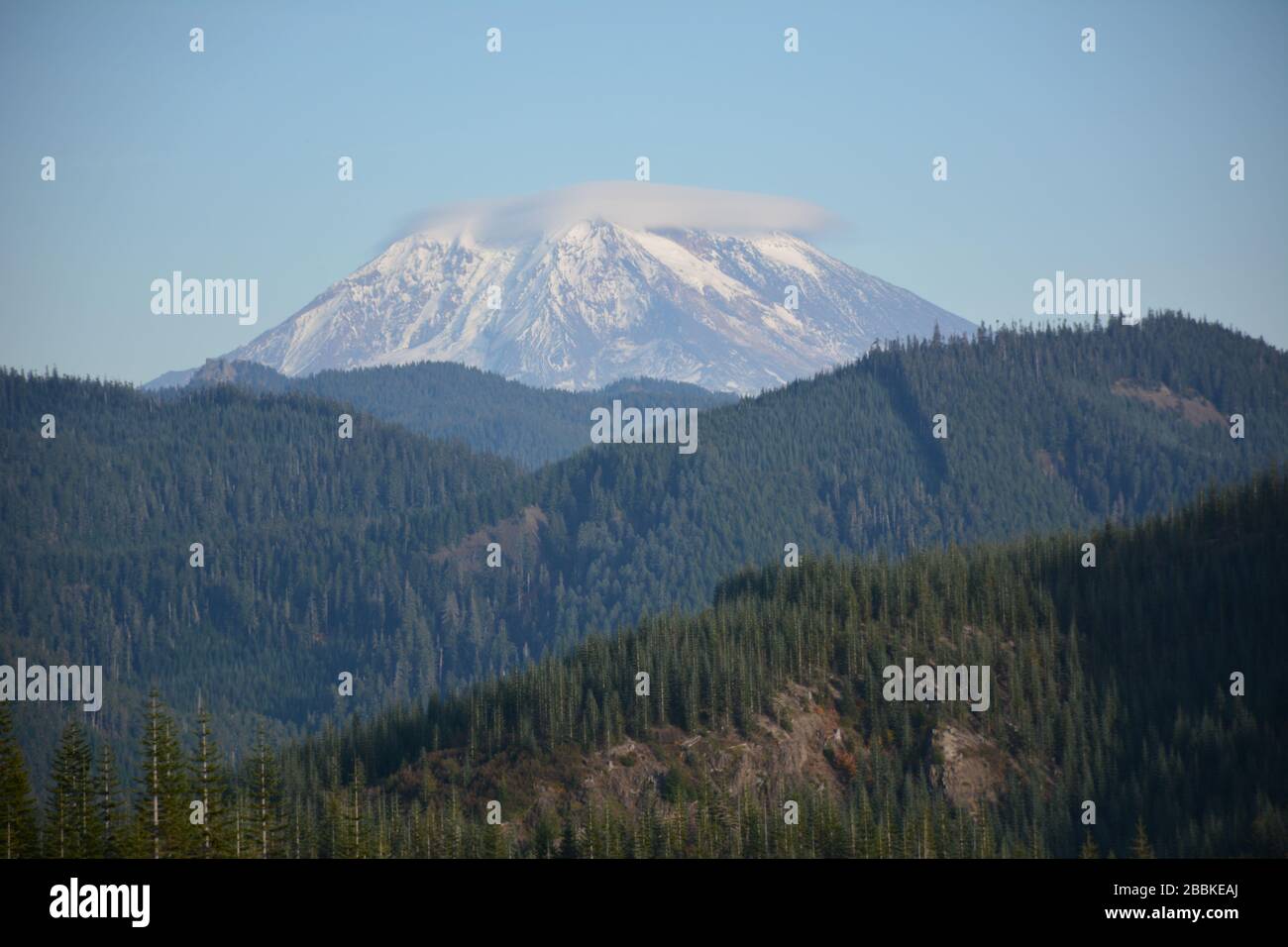 The east side of Mt St Helens seen from behind forested mountain ridges in the Gifford Pinchot National Forest,, Washington State, USA. Stock Photo