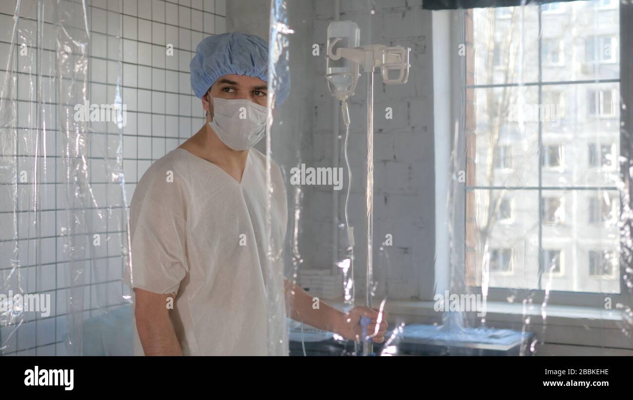 Isolated man despairing at hospital quarantine caused by coronavirus. Stock Photo