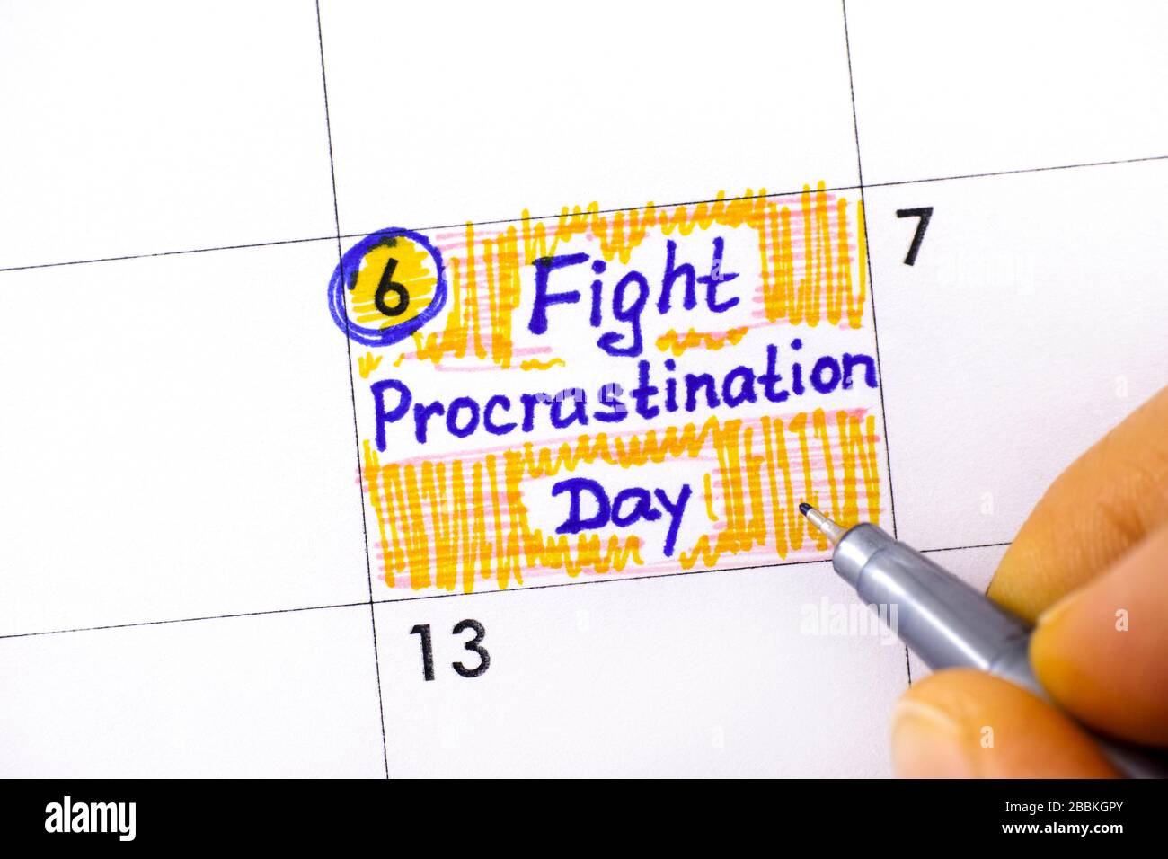 Woman hand with pen writing reminder Fight Procrastination Day in calendar. September 06. Stock Photo