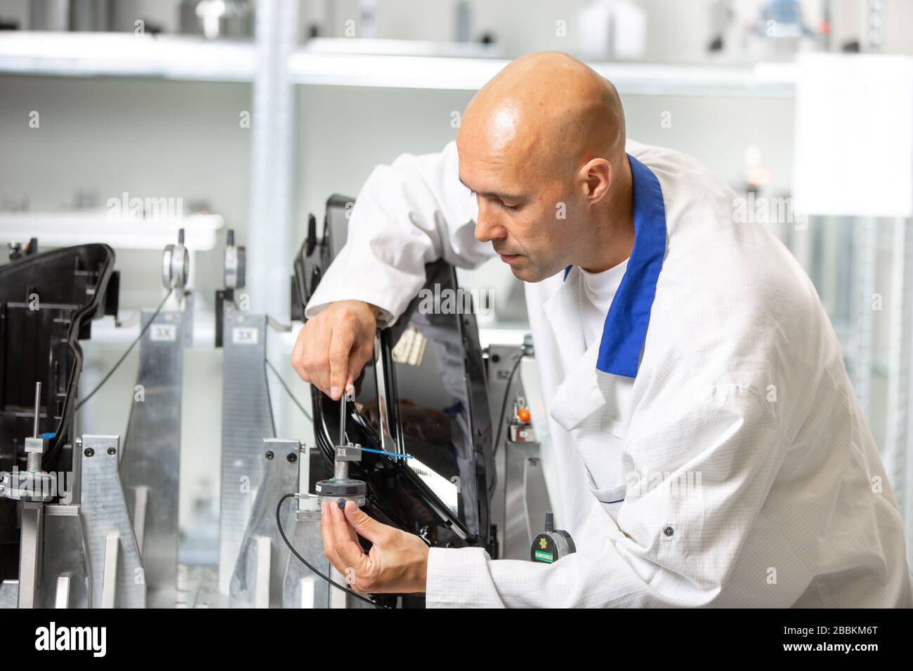 Quality engineer measuring plastic components by digital meter on the