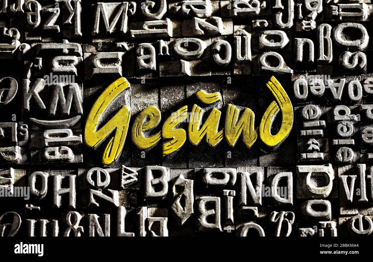 Old lead letters with golden writing show the word Gesund, Germany Stock Photo