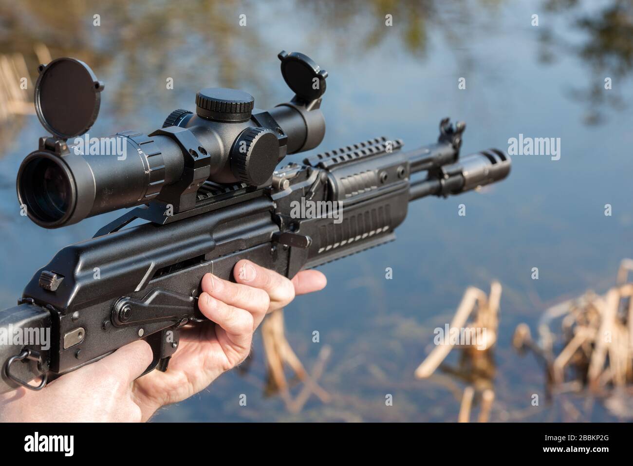 A man is holding a rifle Stock Photo