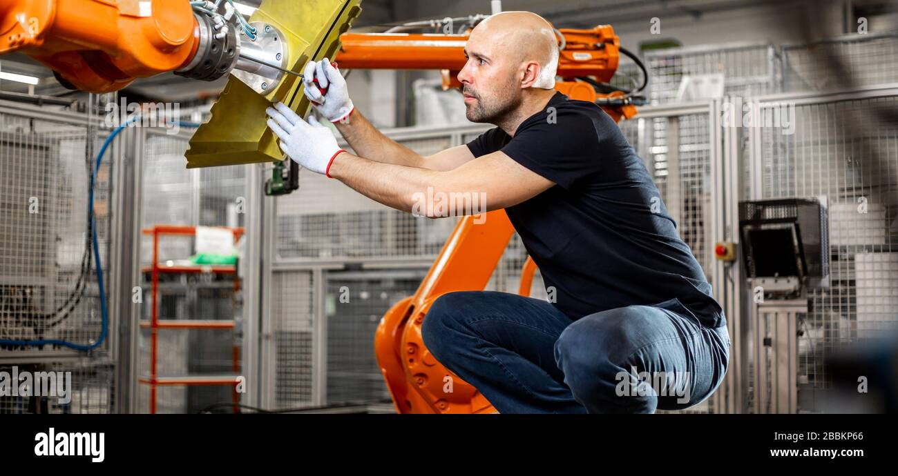 Engineer repairing an automatic robot amrs in automotive, smart factory, industrial concept Stock Photo