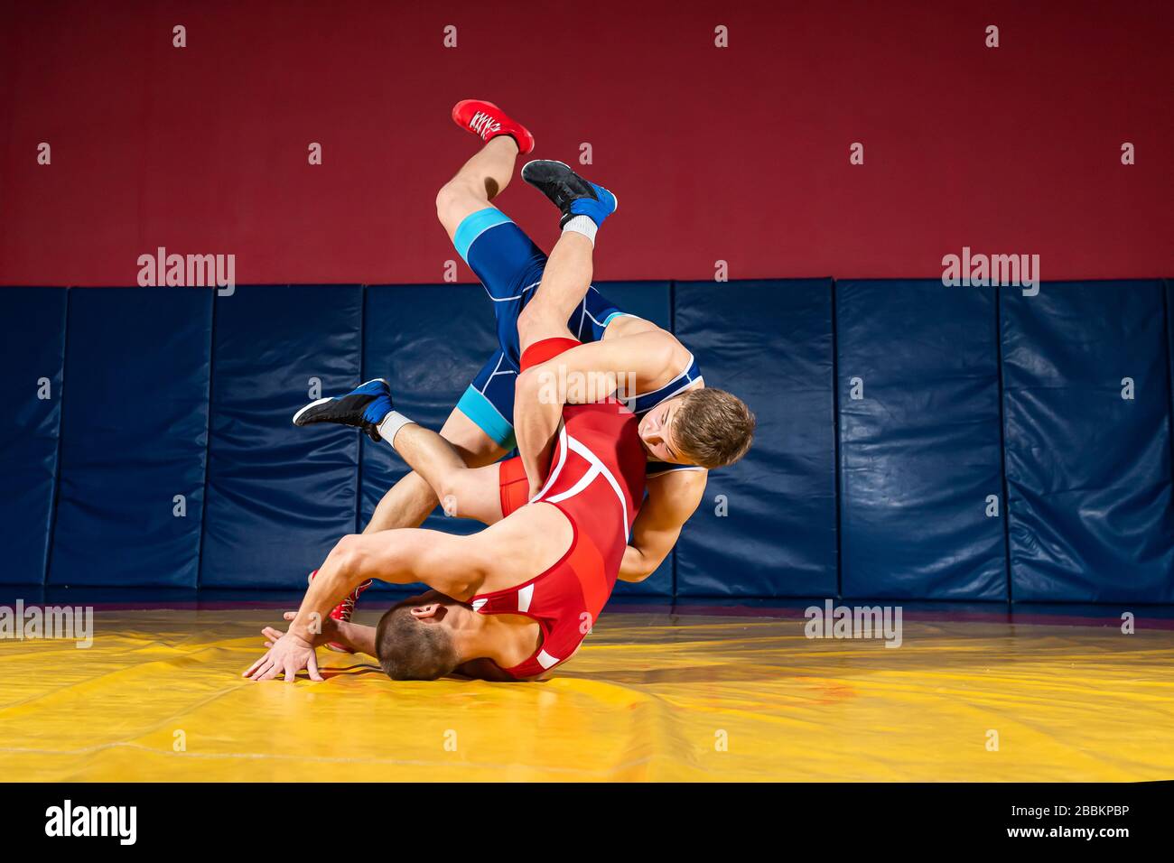 Men in wrestling tights and wrestlers holds the foot of a wrestler boy on a  white isolated background. Dad and son have been fooling around forever.Te  Stock Photo - Alamy