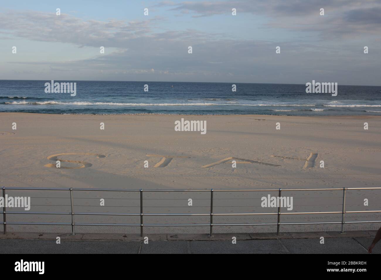 SYDNEY, AUSTRALIA, 1 Apr 2020, 'Stay Home' appears written in the sand on Sydney's Bondi Beach, amid both a coronavirus outbreak in the suburb of Bondi and restrictions from the state government to curb the spread of the disease, limiting people to exercise only in groups no larger than two. Credit: Sebastian Reategui/Alamy Live News Stock Photo