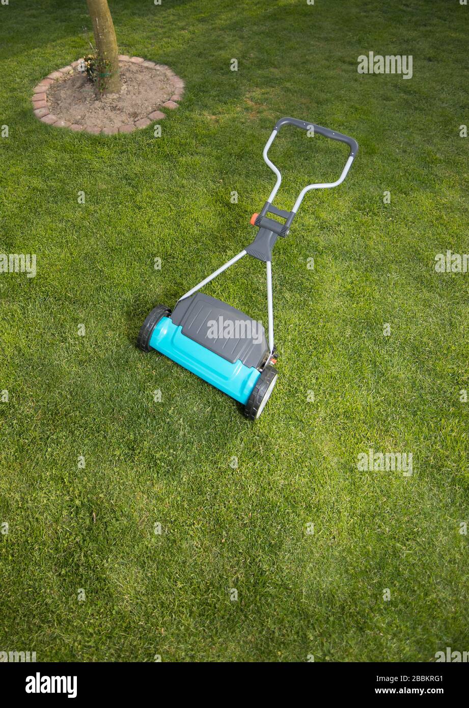 Lawnmover hand held machine. Hand lawn mower. Lawn mower on a green meadow Stock Photo Alamy