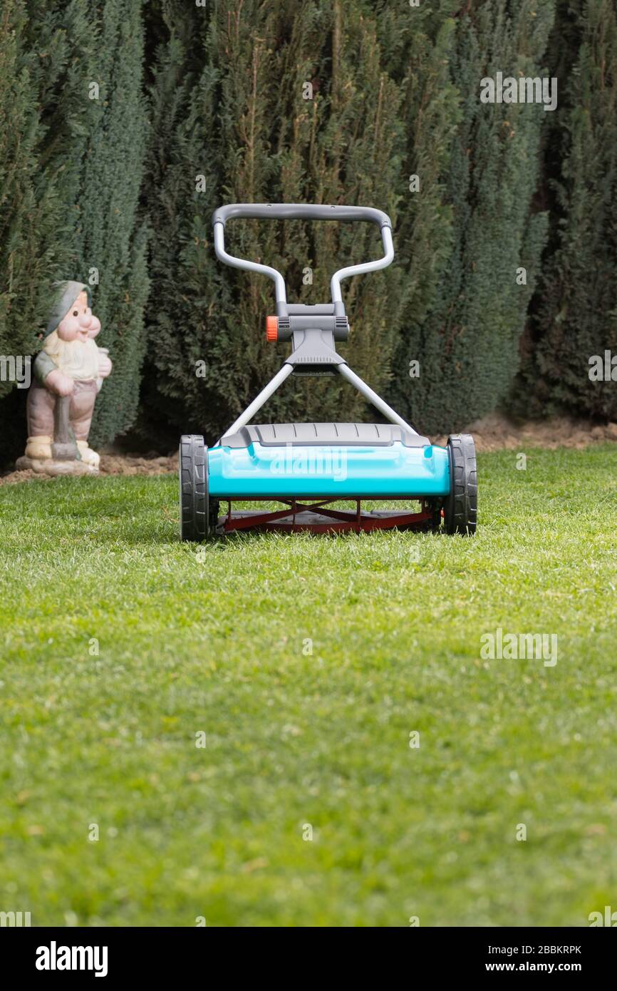 Lawnmover hand held machine. Hand lawn mower. Lawn mower on a green meadow Stock Photo Alamy