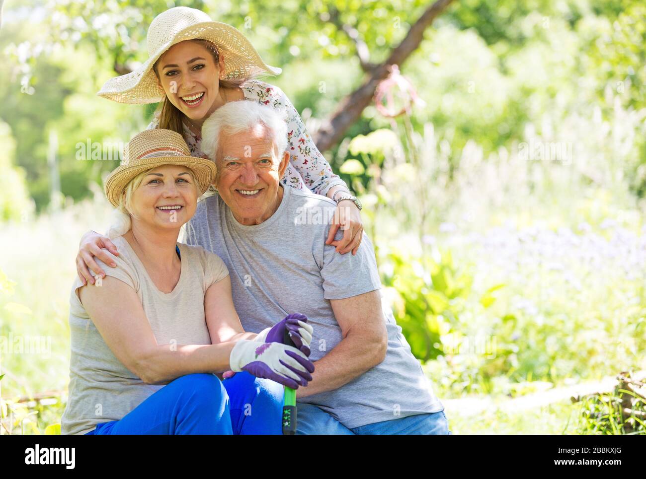 Grandparents with adult granddaughter Stock Photo