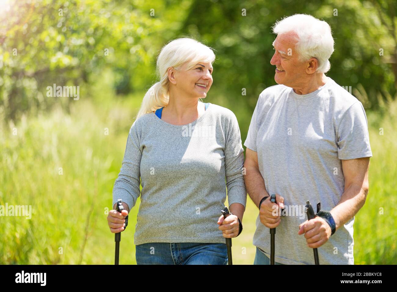 Senior Couple Exercising In Park Stock Photo
