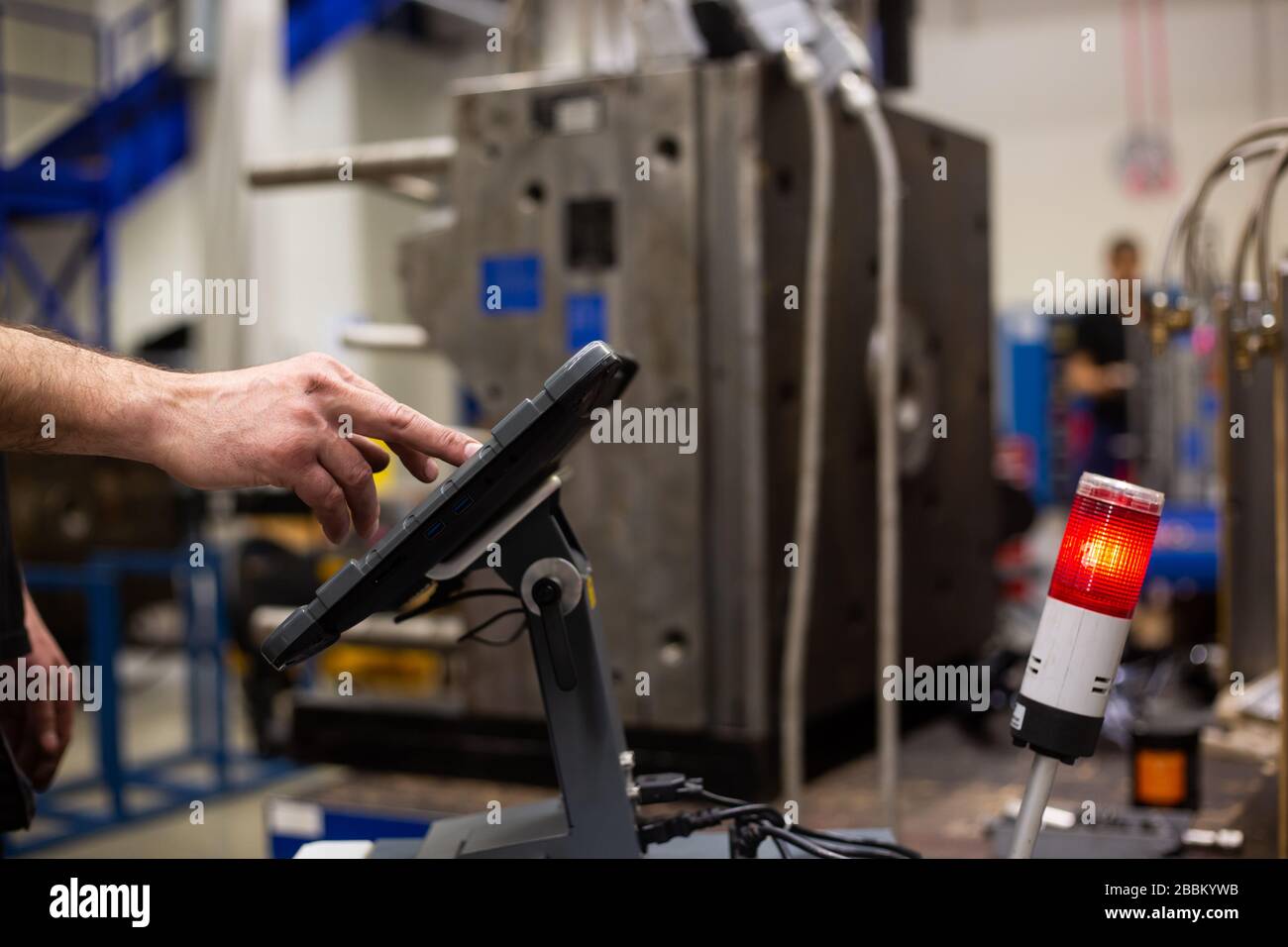 Repairman doing maintenance on the mold injection for plastic components, industrial concept Stock Photo