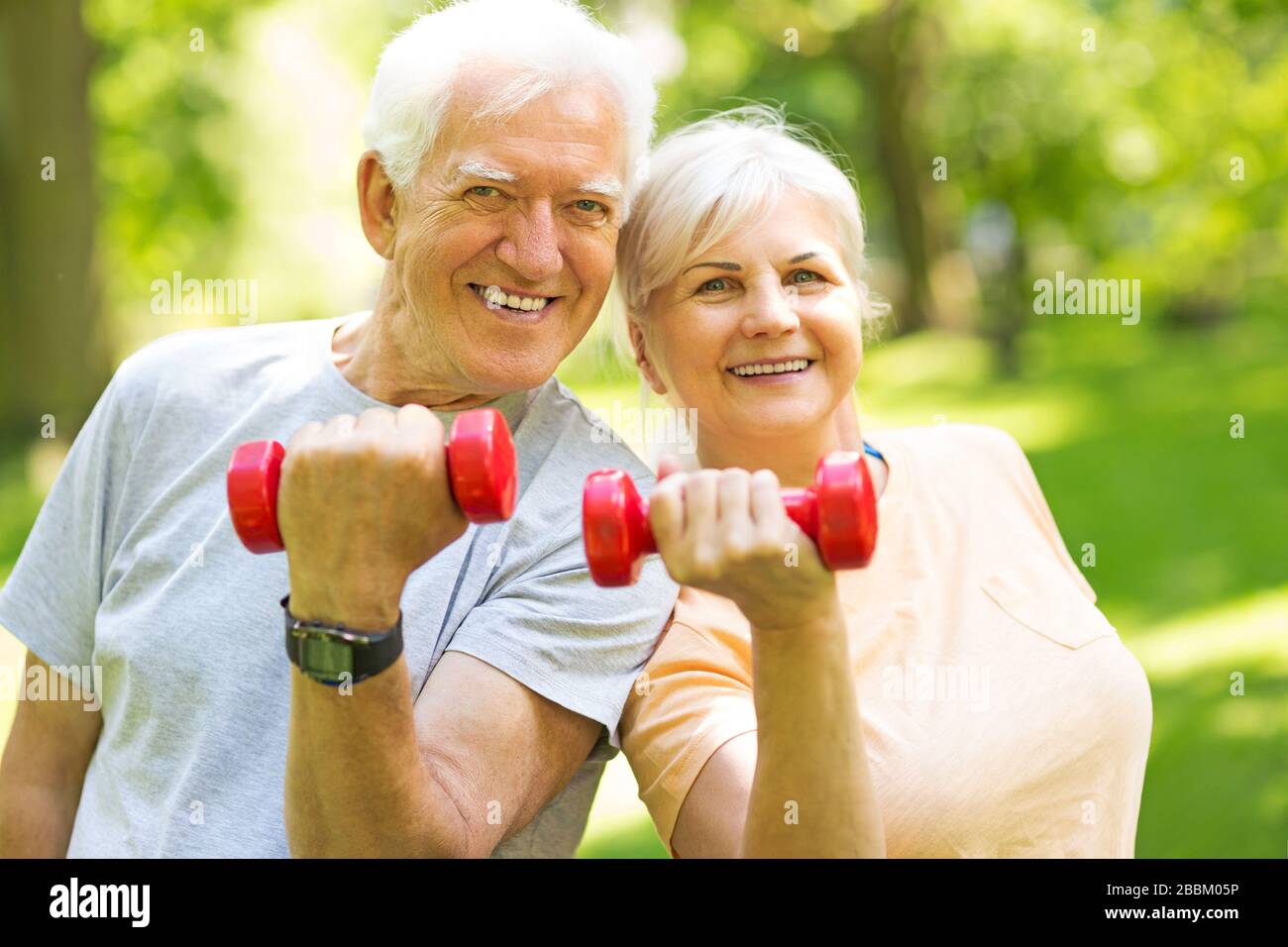 Senior Couple Exercising In Park Stock Photo - Alamy