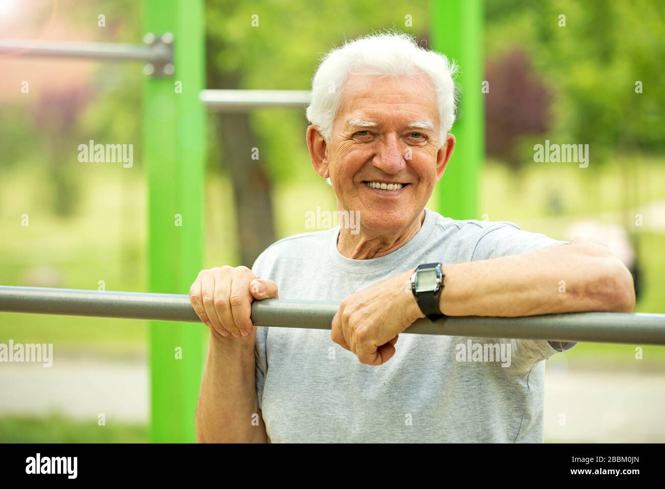 Senior Man Exercising In Park Stock Photo