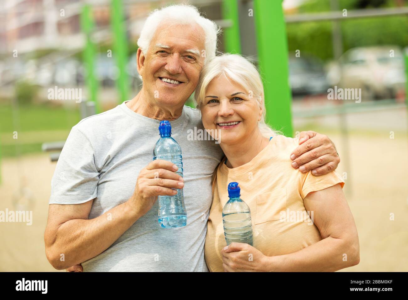 Senior Couple Exercising In Park Stock Photo