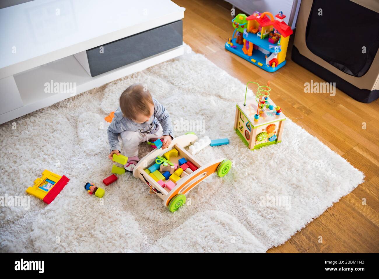 Portrait of one year old baby girl indoors in bright room Stock Photo