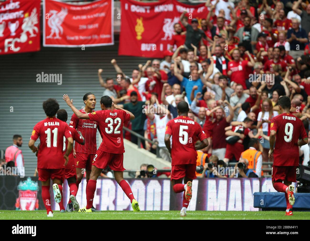 Liverpool's Joel Matip celebrates scoring his side's first goal of the game with team-mate Virgil van Dijk Stock Photo
