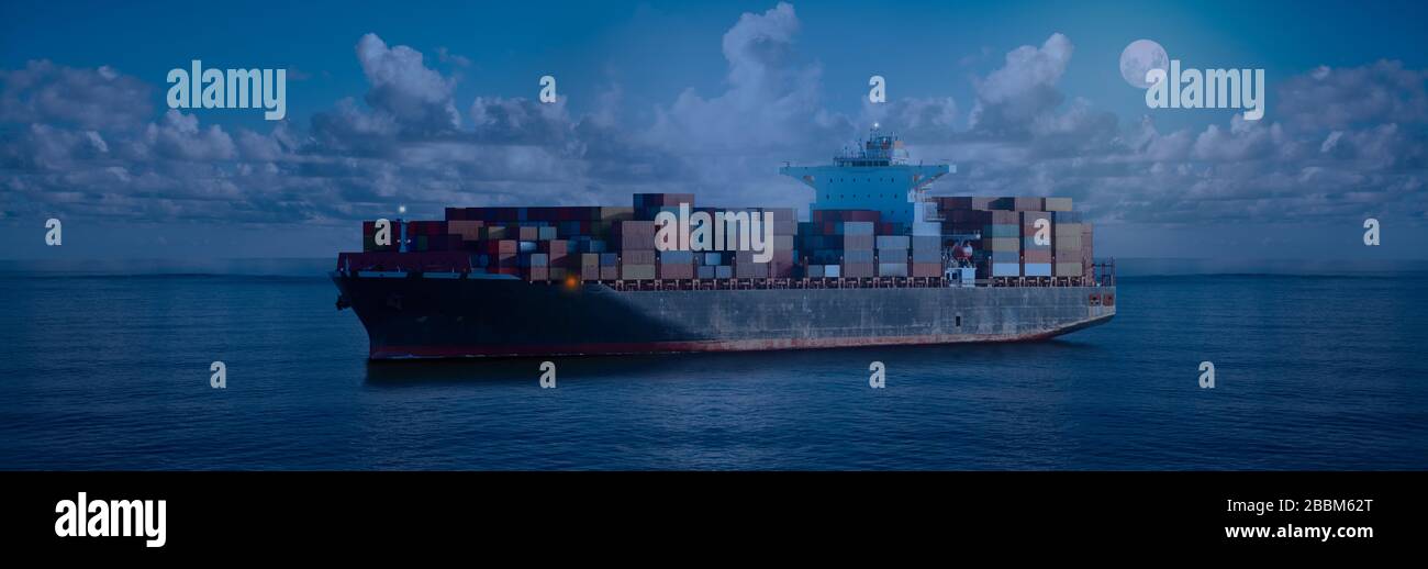 Mighty container ships in ocean at night underway performing import and export marine cargo transportation. Commercial goods industry and maritime car Stock Photo