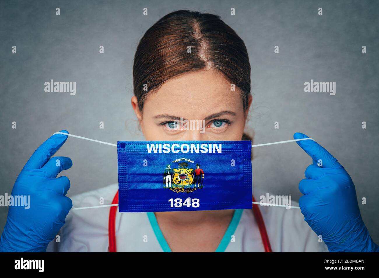 Coronavirus in U.S. State Wisconsin, Female Doctor Portrait, protect Face surgical medical mask with Wisconsin Flag. Illness, Virus Covid-19 in Wiscon Stock Photo