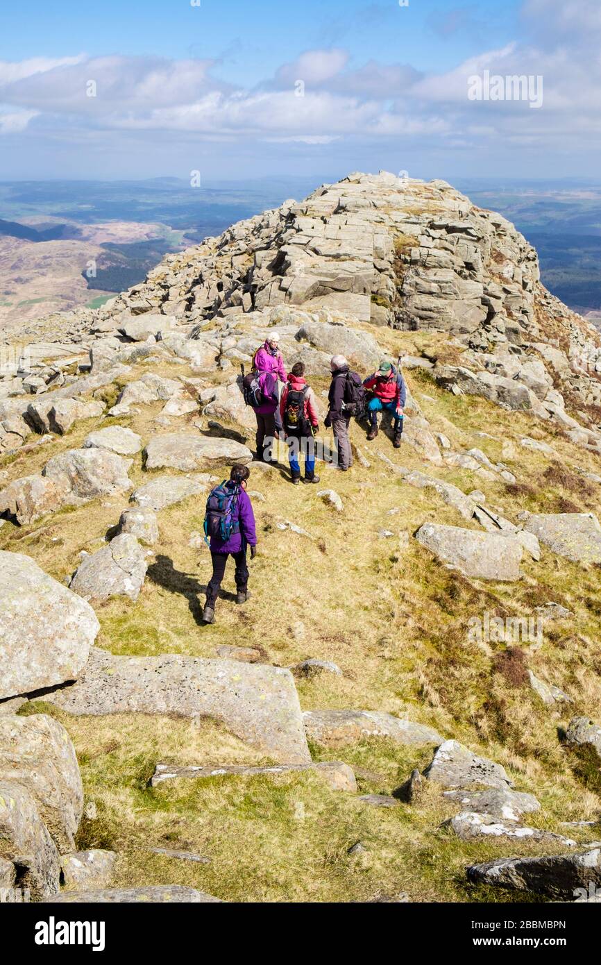 Hikers hiking on Carnedd Moel Siabod summit ridge in mountains of Snowdonia National Park, Capel Curig, Conwy, North Wales, UK, Britain Stock Photo