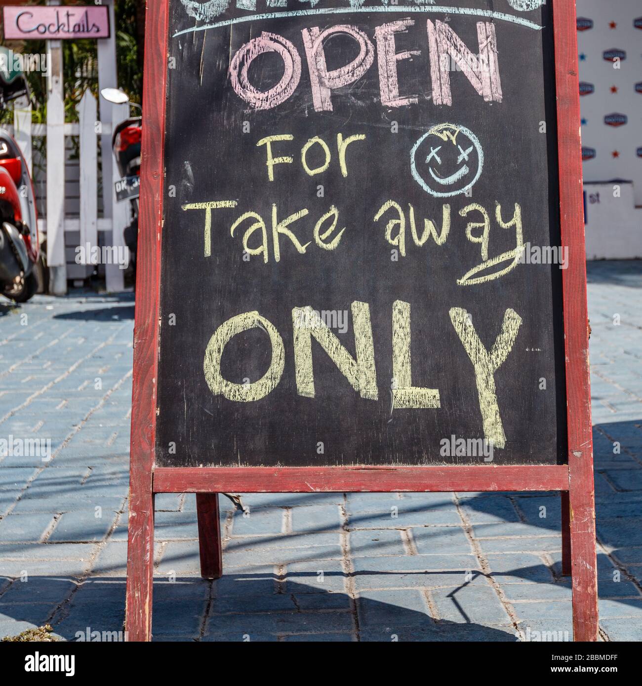 Cafe blackboard sign 'open for take away only' during quarantine for COVID-19. Petitenget, Bali popular tourist area. Indonesia. Square image. Stock Photo
