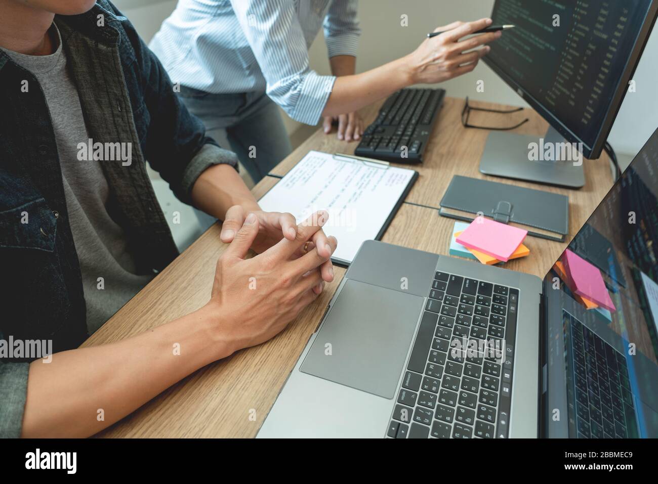 Collaborative work Software engineers website developer technologies or programmer working coding on startup ai application project on screen with par Stock Photo