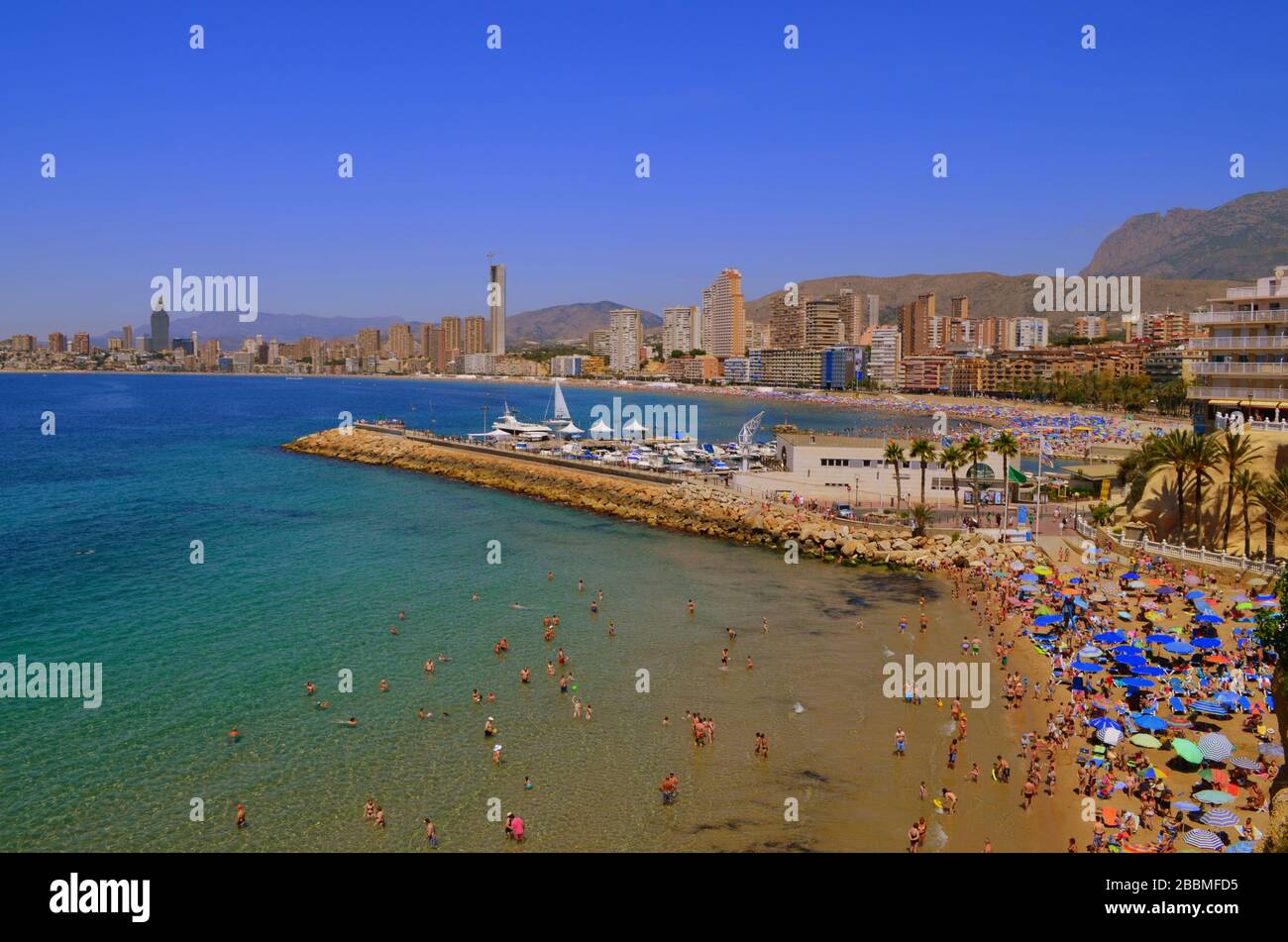 A view of Levante beach in Benidorm taken from Poniente beach, the busier side of the resort. Levante is the quietest part of Benidorm. Stock Photo