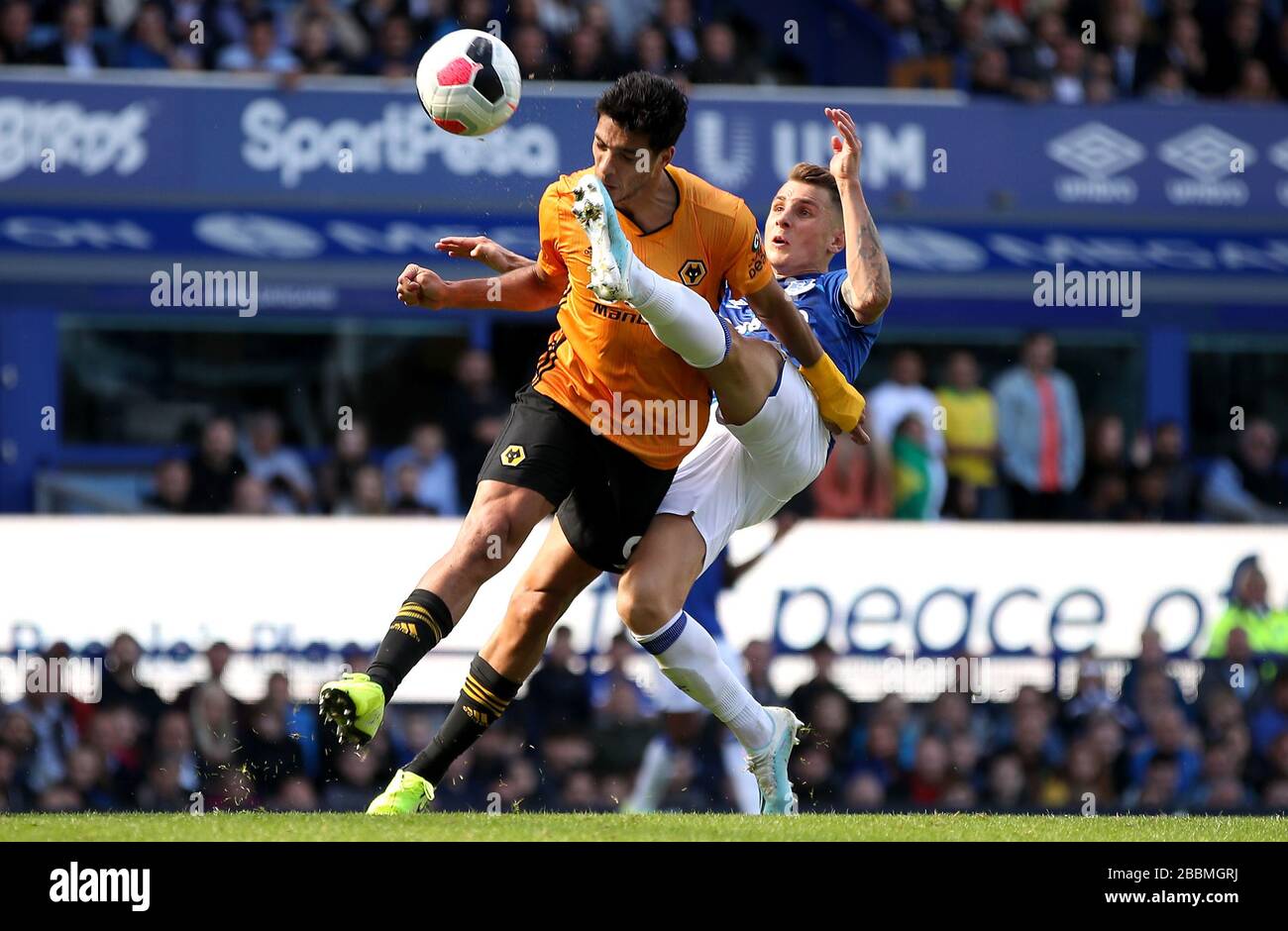 Wolverhampton Wanderers' Raul Jimenez (left) gets kicked in the face by Everton's Lucas Digne after scoring his side's second goal Stock Photo