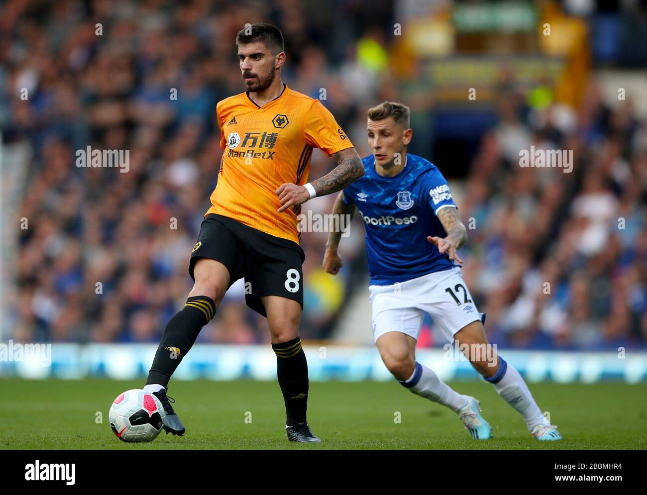 Wolverhampton Wanderers's Ruben Neves holds off challenge from Everton's Lucas Digne Stock Photo