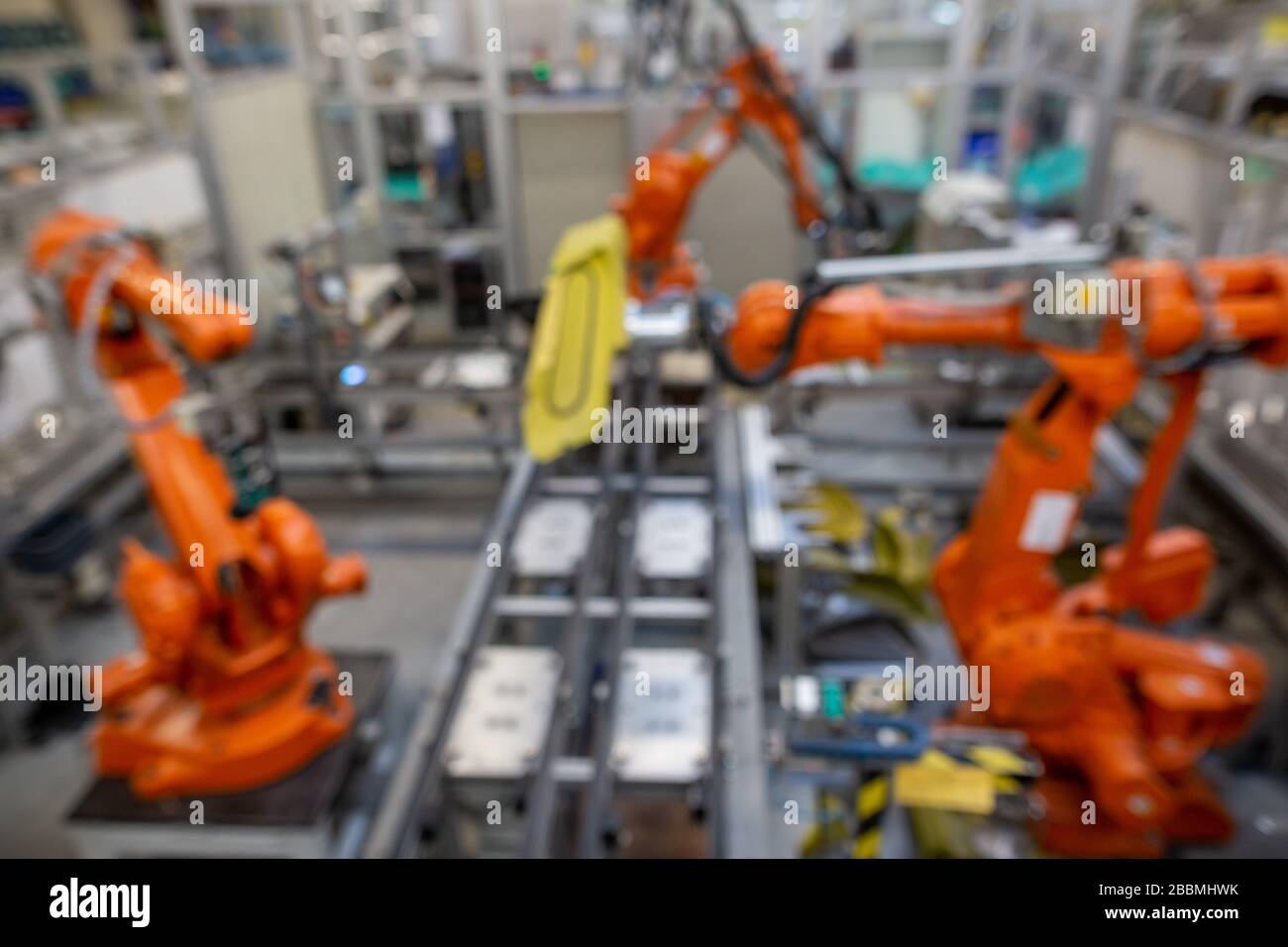 View to three automatic robots arm machine in automotive industrial, smart factory, blur image for background Stock Photo
