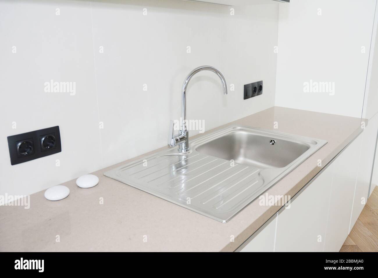 Modern kitchen metal faucet and  kitchen sink. Stock Photo