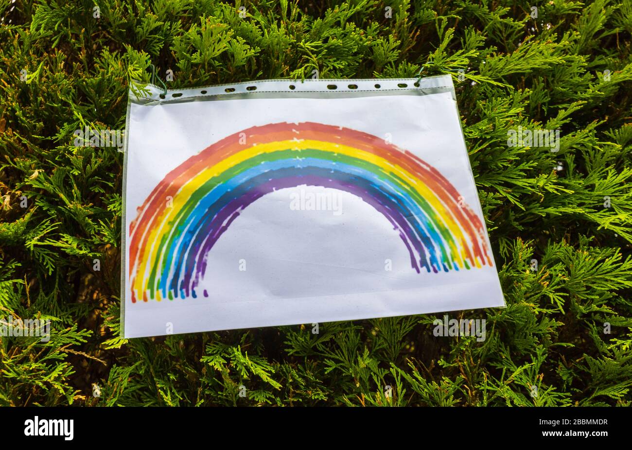 Child's picture of a rainbow in a Woking street as people try to stay positive isolated in their homes during the coronavirus pandemic and lockdown Stock Photo