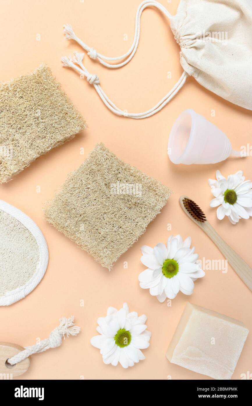 Flowers and accessories for personal hygiene. Zero waste layout on yellow background. Stock Photo