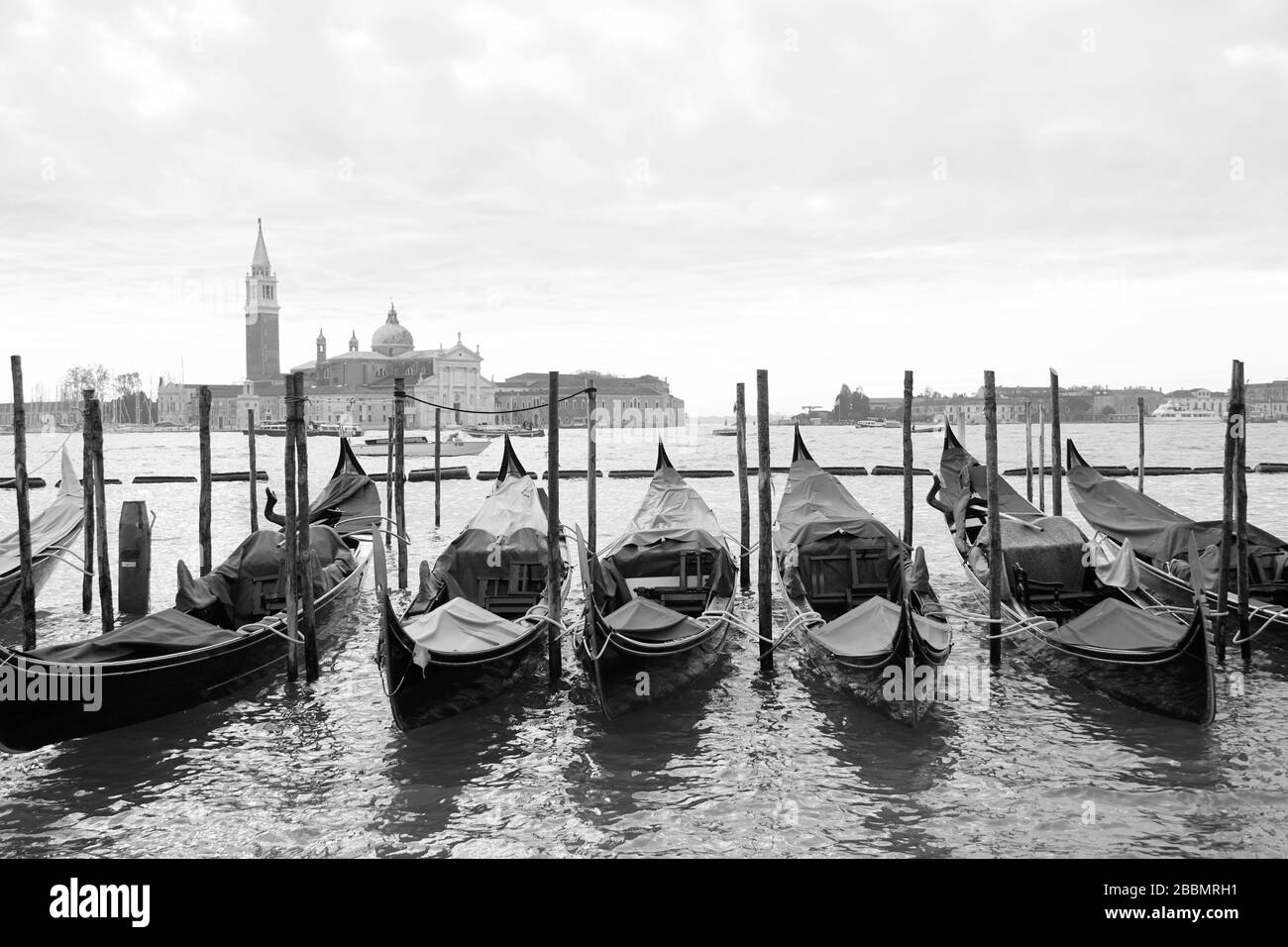 Gondolas in the front and the Saint George Greater church at the background in Venice, northern Italy. Stock Photo