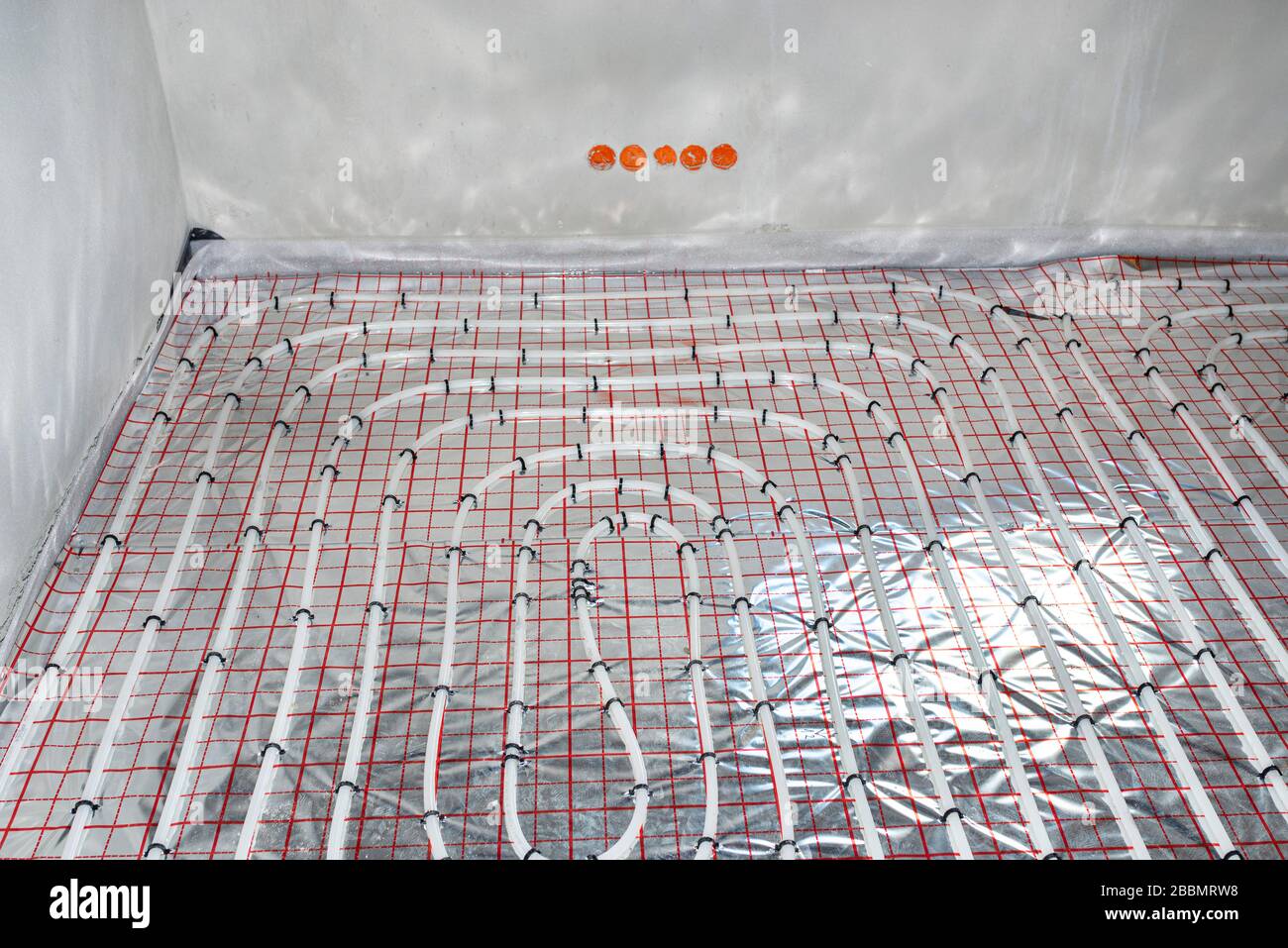 White pipes of underfloor heating systems, distributed in an individual