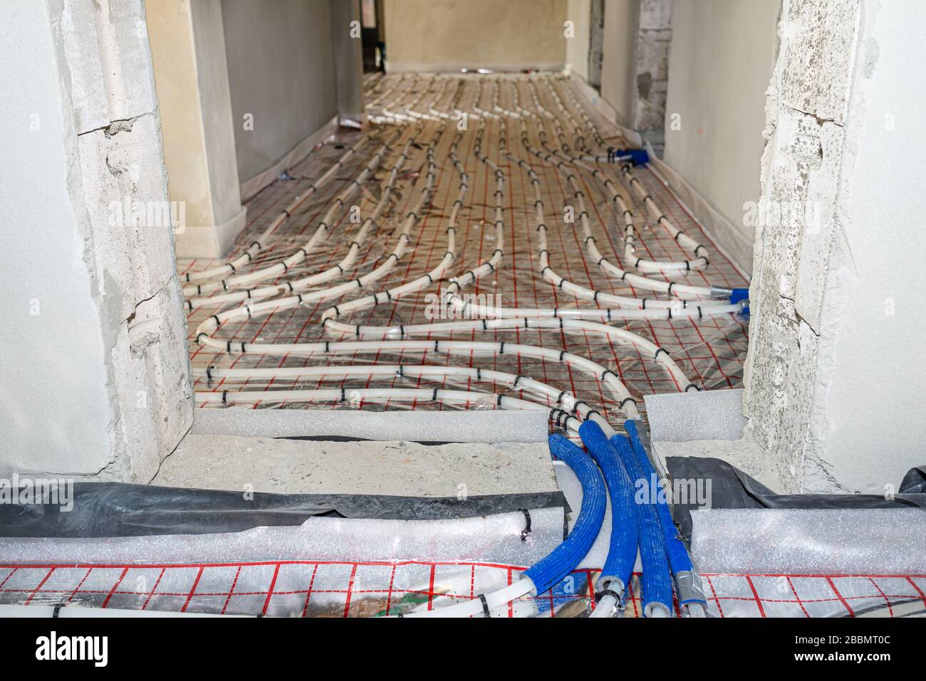 White pipes of underfloor heating systems, arranged in an individual