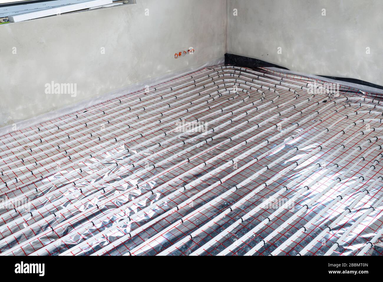 White pipes of underfloor heating systems, distributed in an individual  family house on insulating foil Stock Photo - Alamy