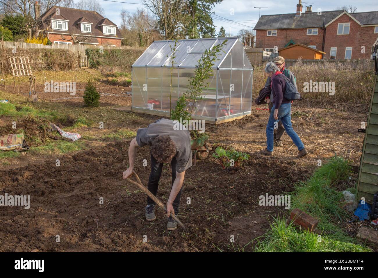 Working on a new allotment in order to grow their own food and stay healthy Stock Photo