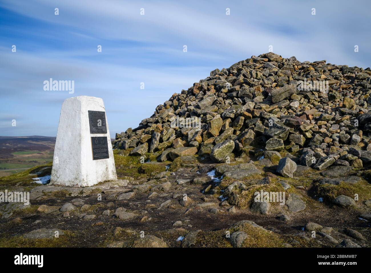 High summit of Beamsley Beacon (trig point, memorial plaques, historic cairn rocks, upland hills, scenic rural view) - North Yorkshire, England, UK. Stock Photo