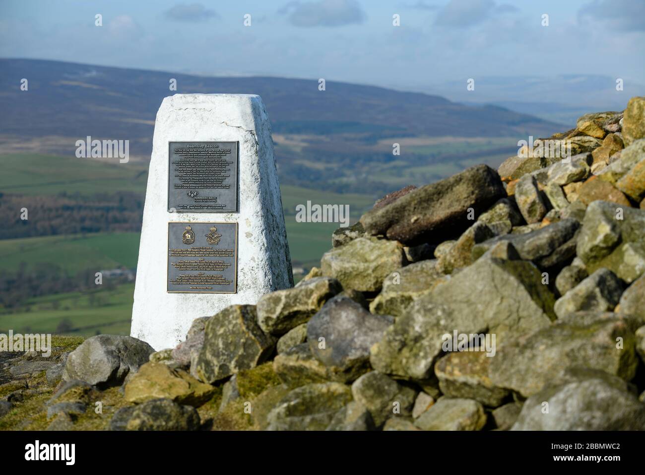 High summit of Beamsley Beacon (trig point, memorial plaques, historic cairn rocks, upland hills, scenic rural view) - North Yorkshire, England, UK. Stock Photo