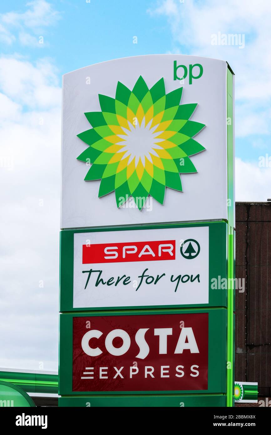 Filling station sign indicating BP fuel, an in store SPAR shop and Costa Coffee express cafe Stock Photo