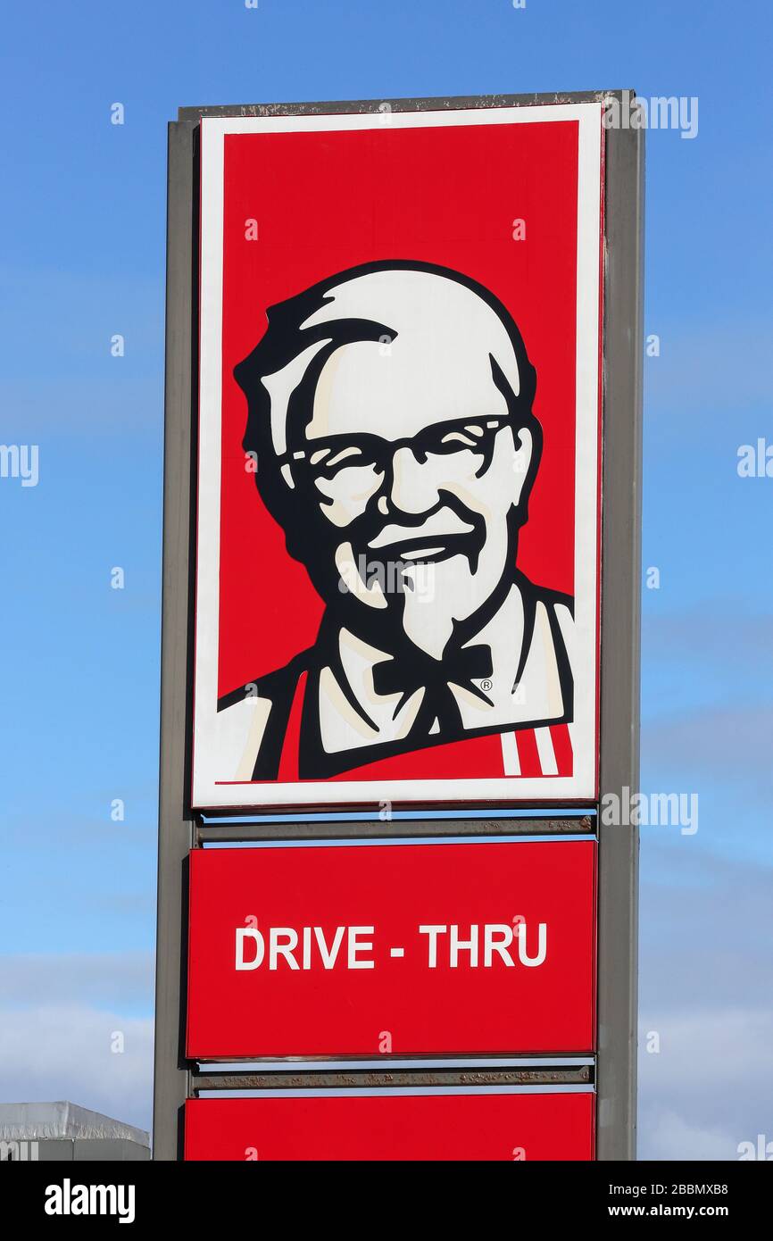 Logo signpost for Kentucky Fried Chicken fast food drive thru restaurant Stock Photo
