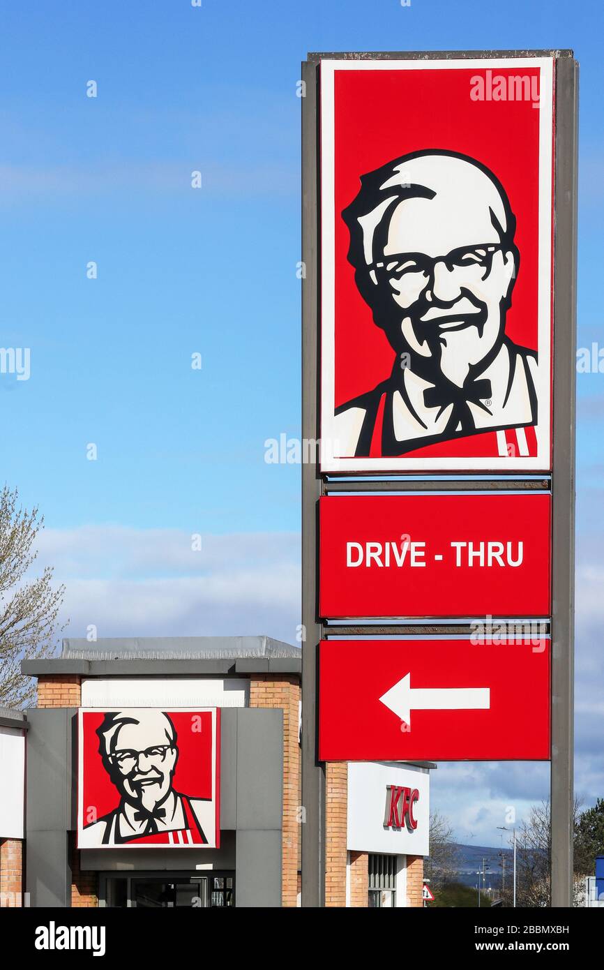 Logo signpost for Kentucky Fried Chicken fast food drive thru restaurant Stock Photo