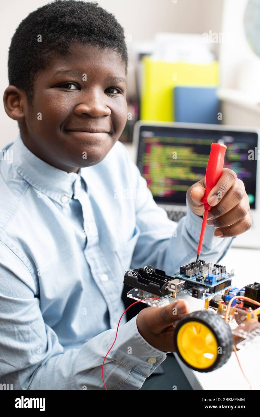 Premium Photo  Asian little boy programming code to robot machine