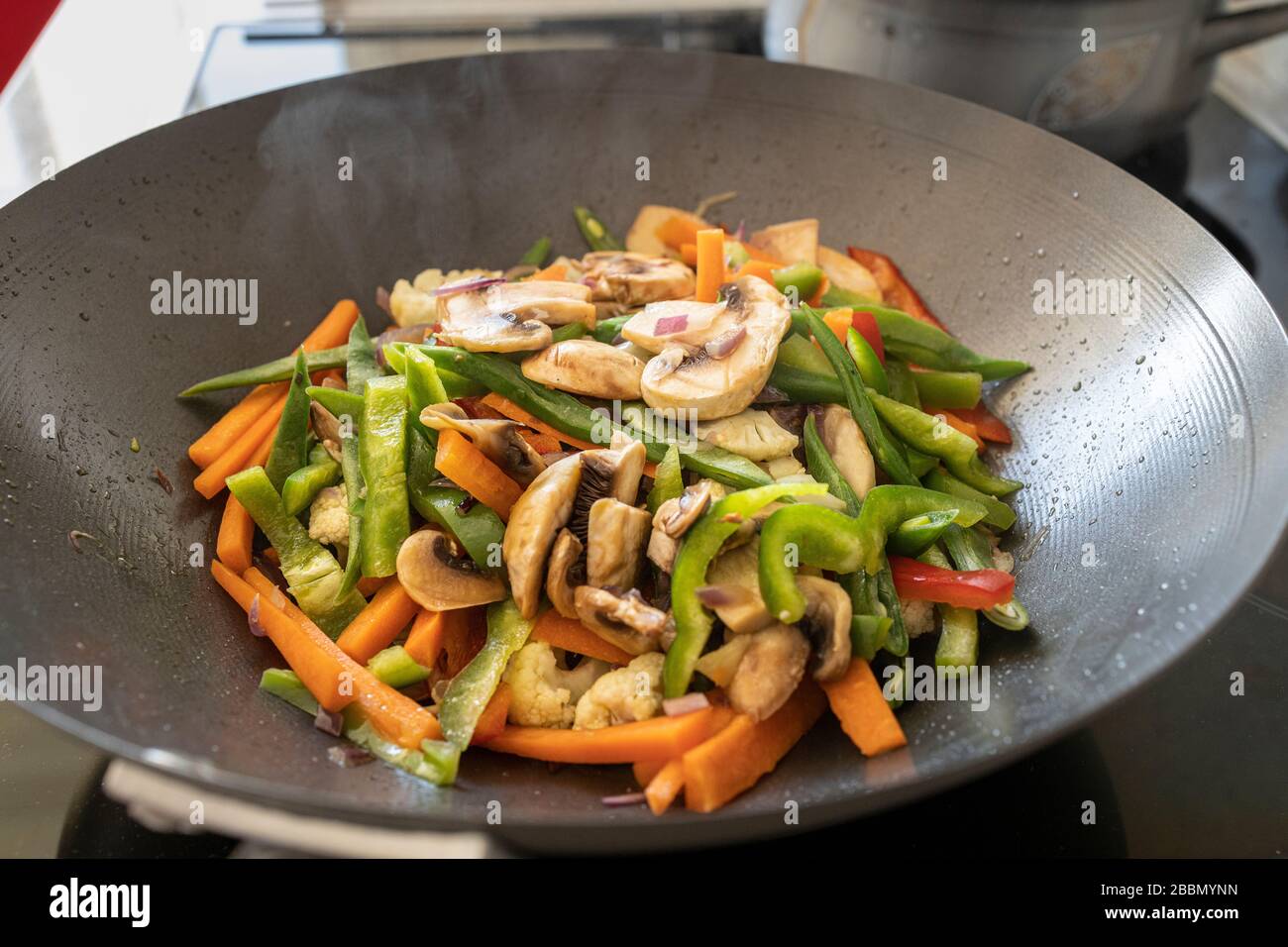 Cooking stir fry vegetables in a wok, Playa San Juan, Tenerife, Canary