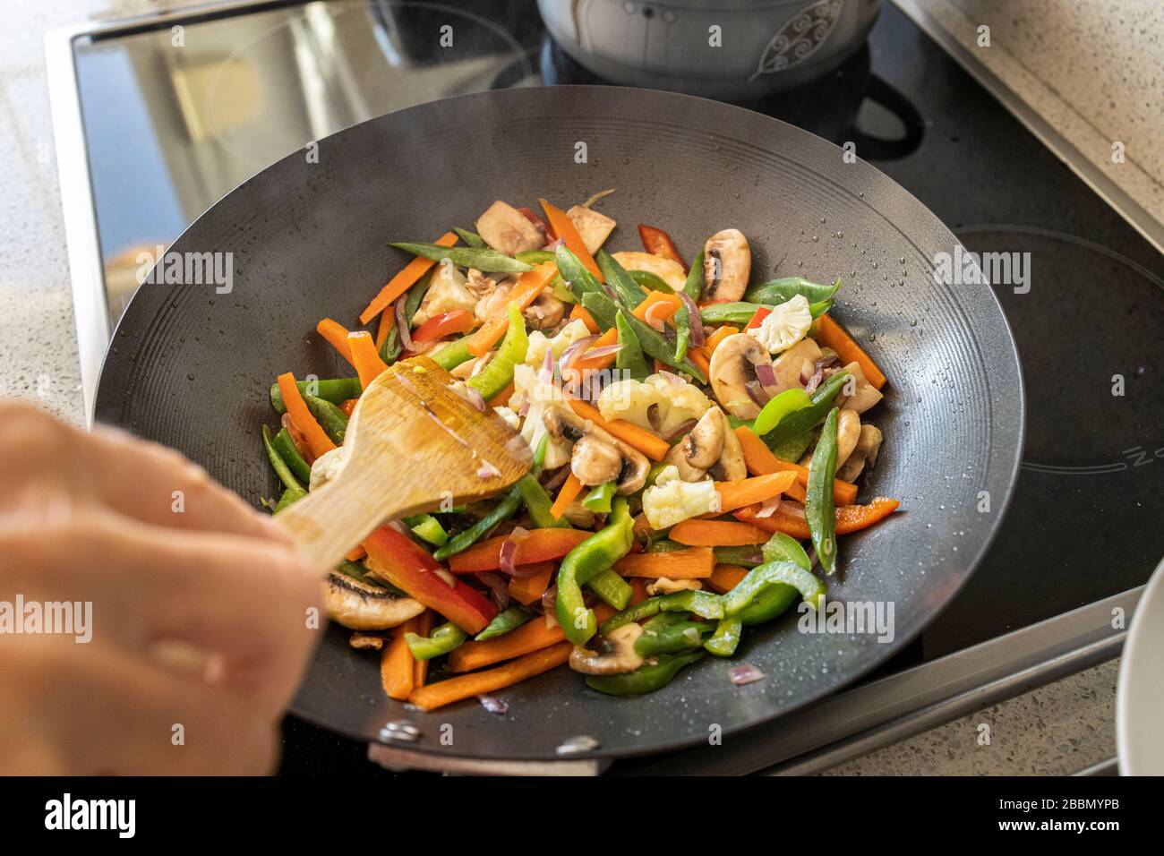 Cooking stir fry vegetables in a wok, Playa San Juan, Tenerife, Canary