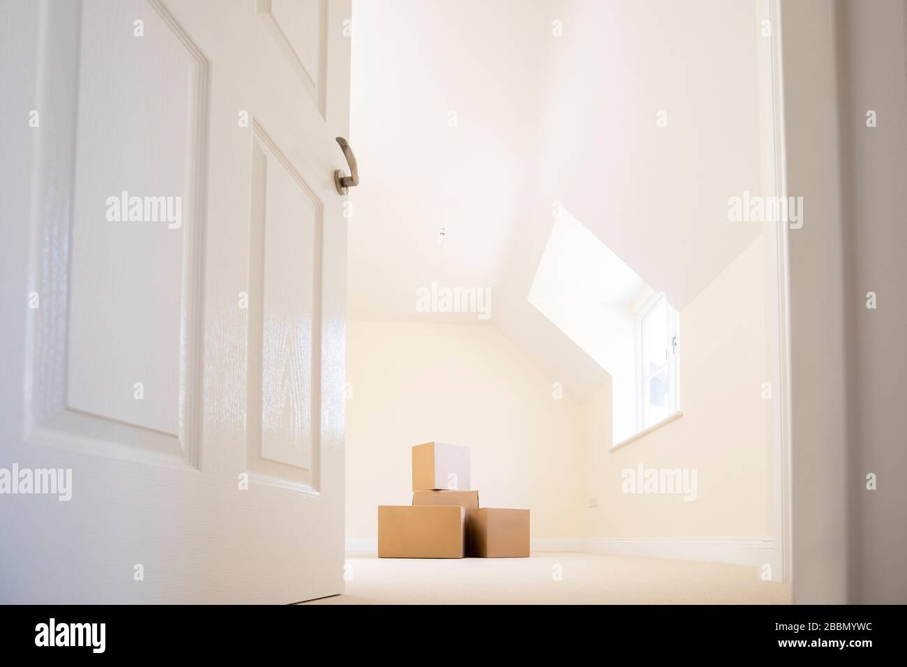 Cardboard Boxes Stacked In New Home On Moving Day Stock Photo