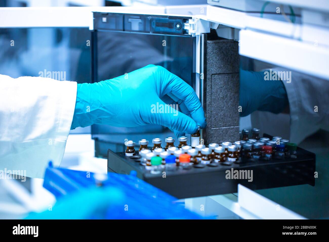 Pharmacist, scientist inserts some samples for chromatographic testing, pharmacy industrial concept Stock Photo