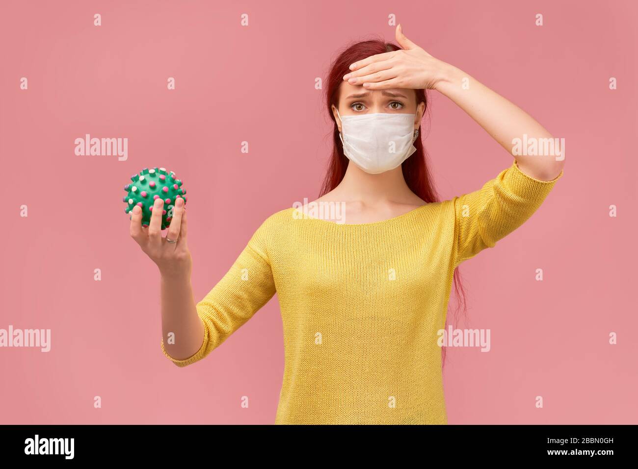 a Woman measures temperature on forehead, symptoms Stock Photo Alamy