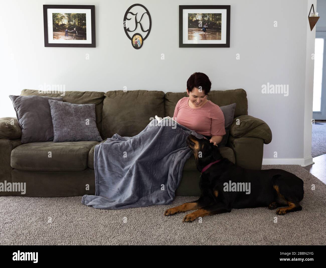 cuddling on the couch with rottweiler Stock Photo